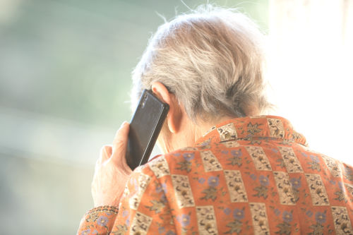 
                      an older patient speaking on a telephone
                    